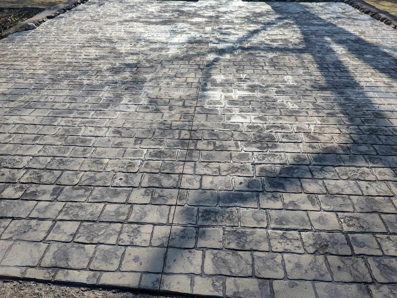 Gray stamped concrete designed to look like brick. Commercial Concrete contractor in Paulding.