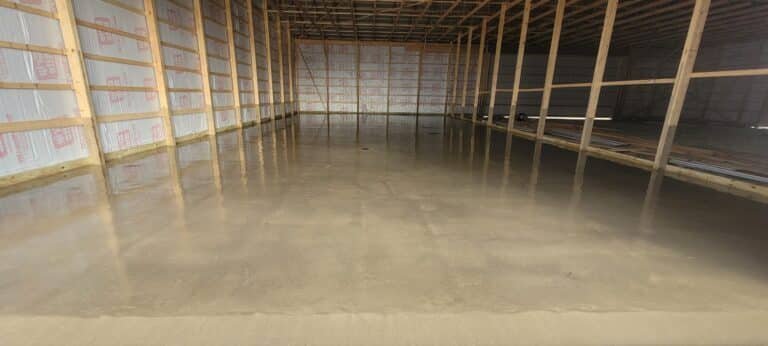 Smooth concrete floor slab inside a 30×40 pole building in northeast Indiana.