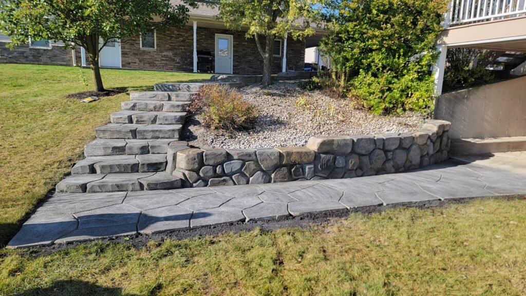 Stamped concrete walkway, stairs and stone-textured retaining wall in Hoagland, Indiana.