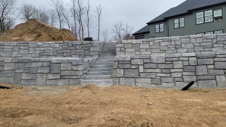 Block retaining wall with integrated steps under construction near Fort Wayne, Indiana.