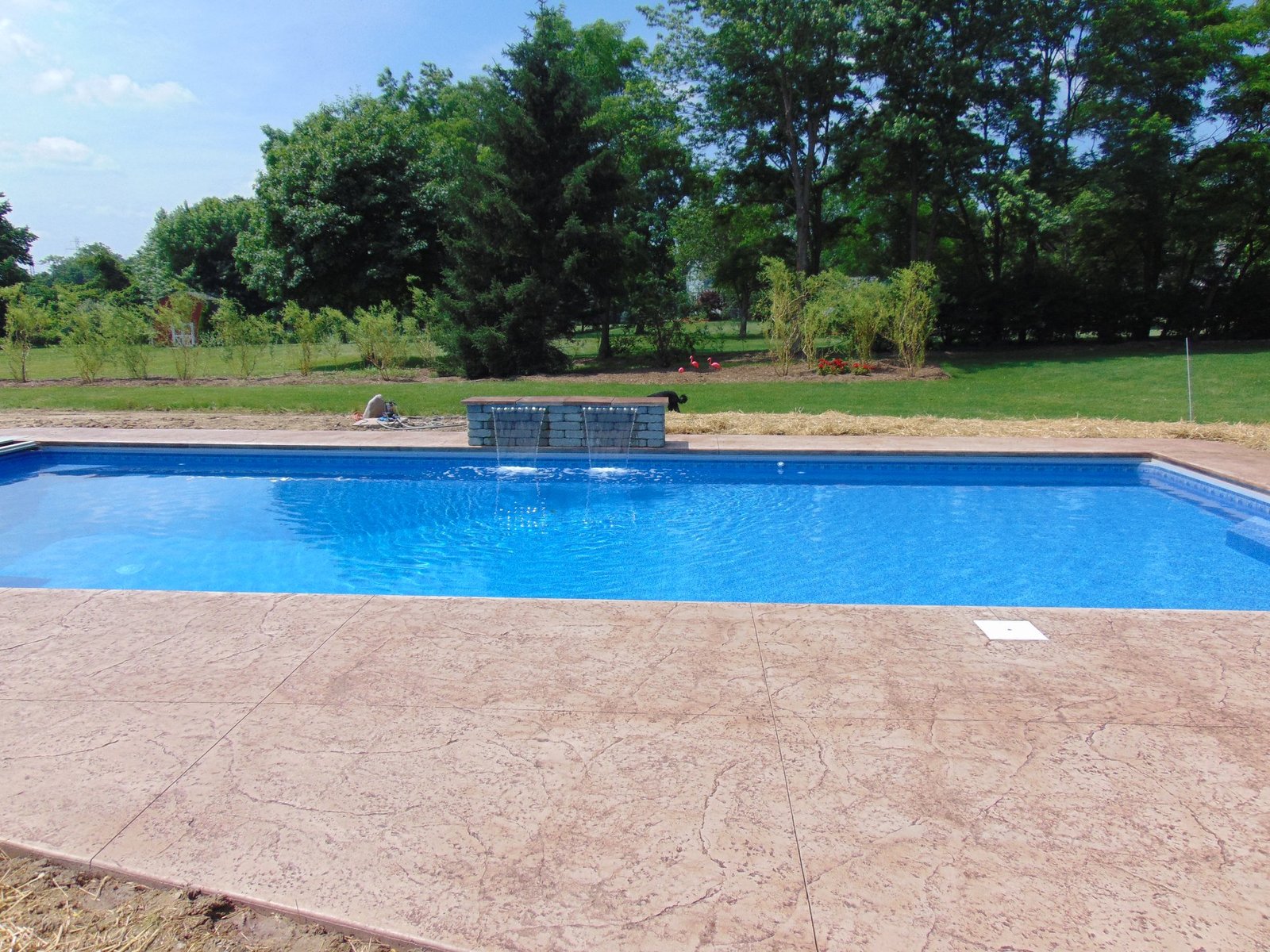Stamped concrete patio surrounding an in-ground pool. Concrete patios in Bluffton.
