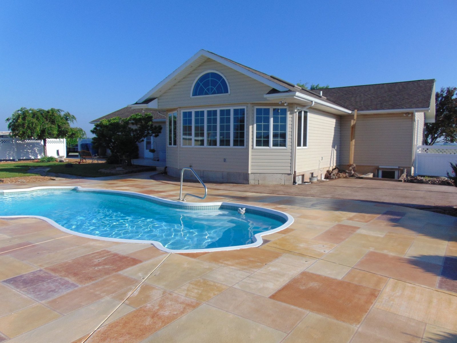 Concrete patio with a pool in the middle. Concrete contractor in Montpelier.