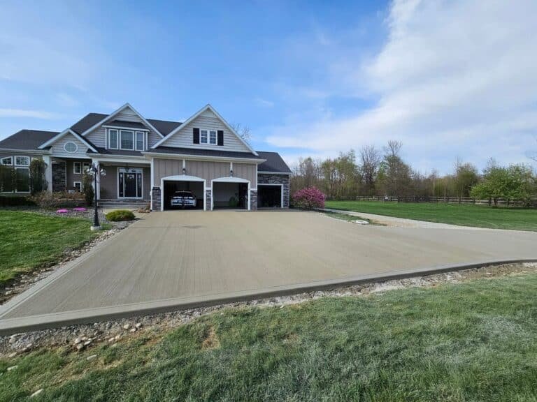 Broom-finished concrete driveway in front of a two-car garage