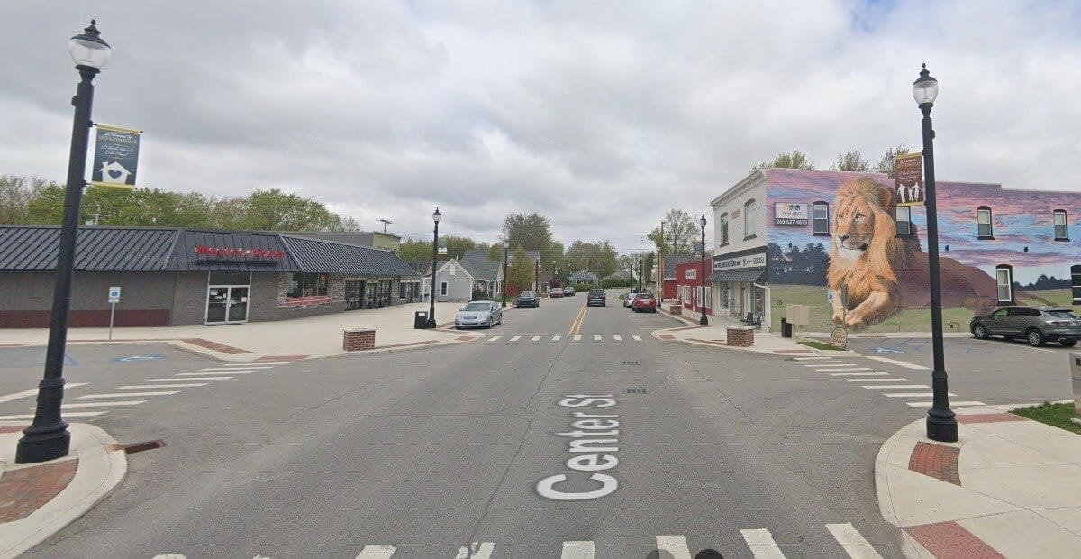 Center Street in downtown Leo-Cedarville, Indiana, with a lion mural on a storefront