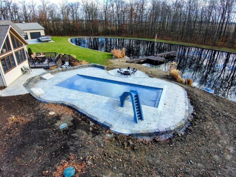 Concrete spa deck surrounded by landscaping